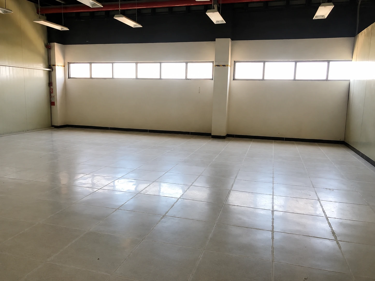 Finished glossy ESD tile floor in an empty room with clerestory windows, Canlubang, Calamba