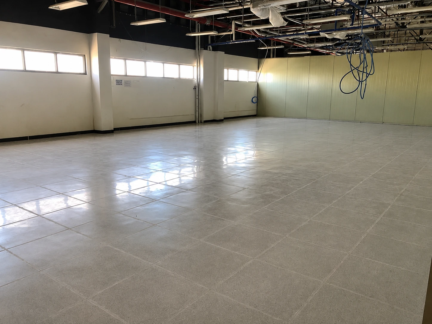 Completed ESD tile floor in an industrial room with ceiling cabling awaiting equipment fit-out