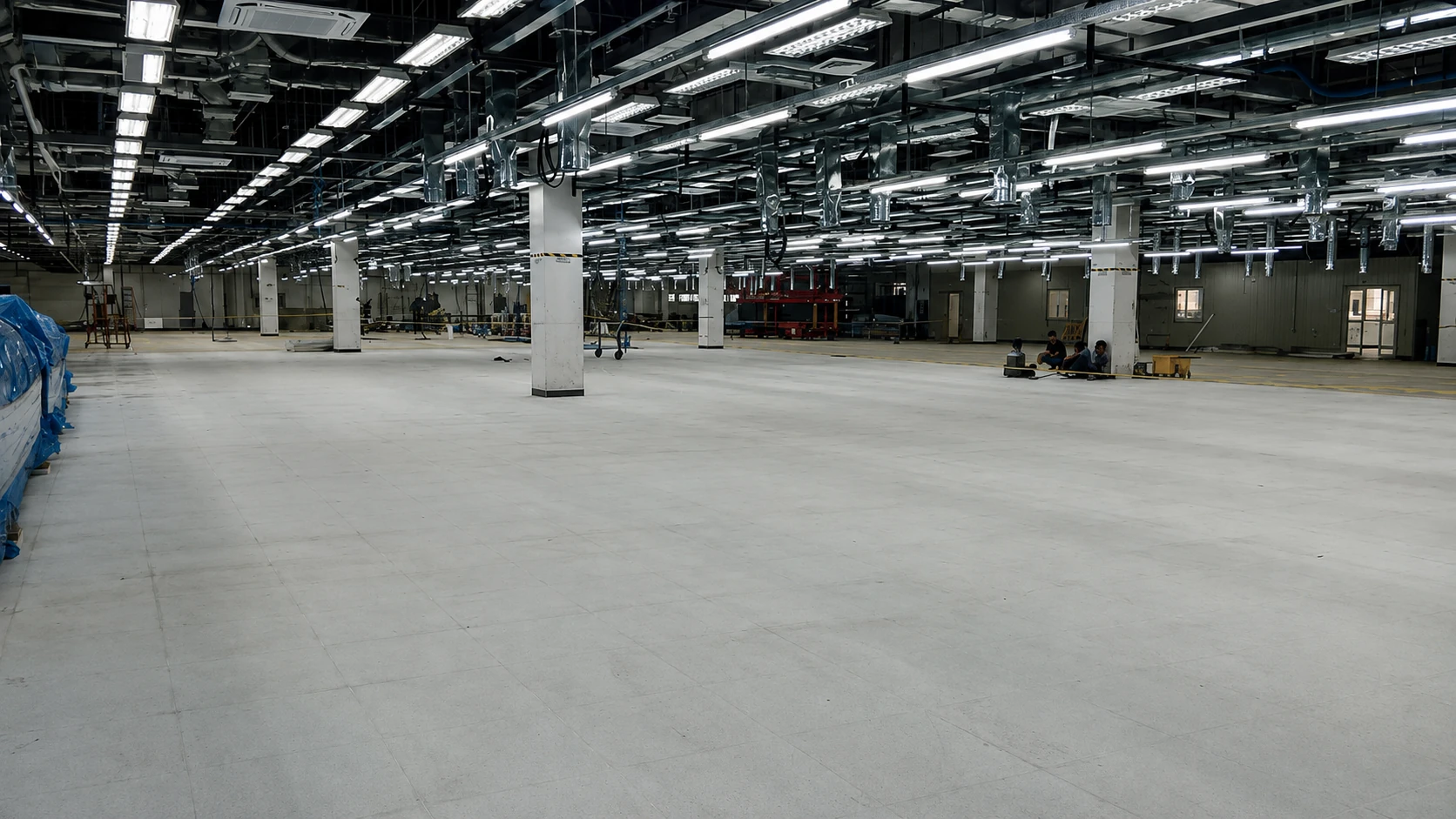 Prepared gray subfloor in a large industrial hall awaiting ESD flooring installation, Canlubang, Calamba