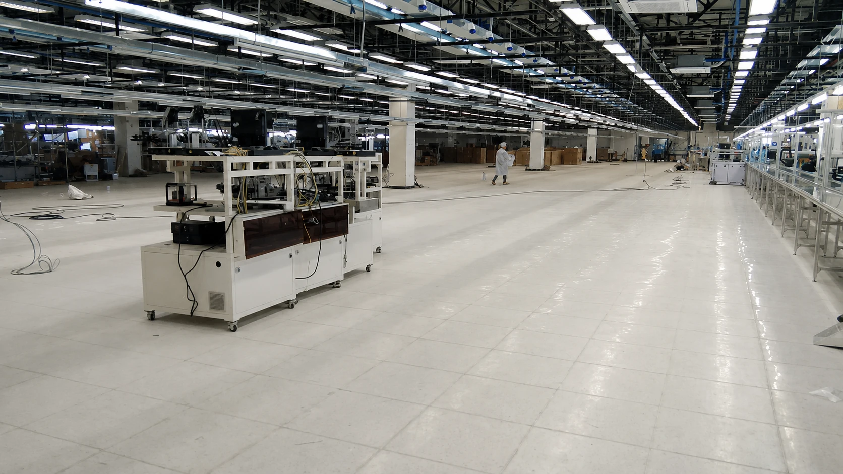 Production equipment positioned on finished white ESD tile flooring in an electronics manufacturing facility
